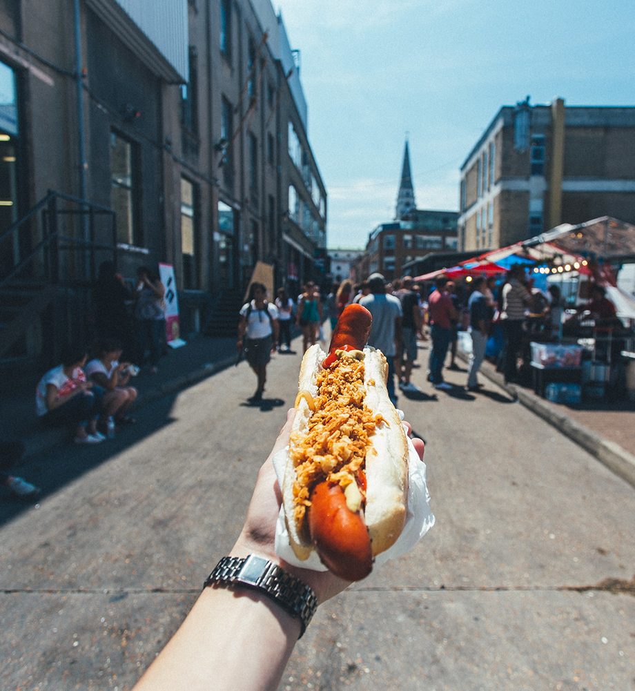 Hot dog in hand on the street
