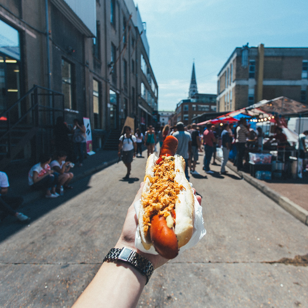 Hot dog in hand on the street